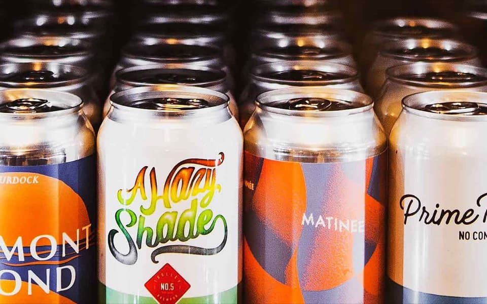 Cans of local craft beer in the cooler at Collective Craft Beer