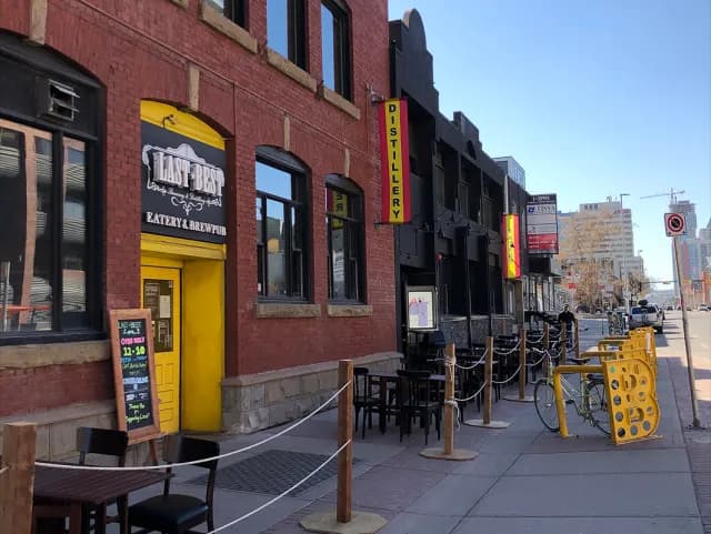 The yellow front door of Last Best on 11th Avenue
