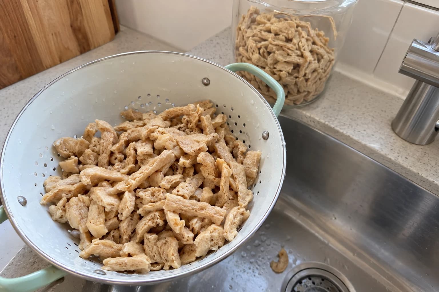 Dry soy curls beside a bowl of soaked soy curls on a bright kitchen counter